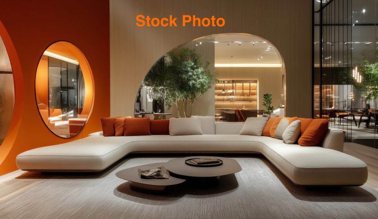 Cozy modern living room featuring a stylish curved sofa and elegant decor in warm tones
