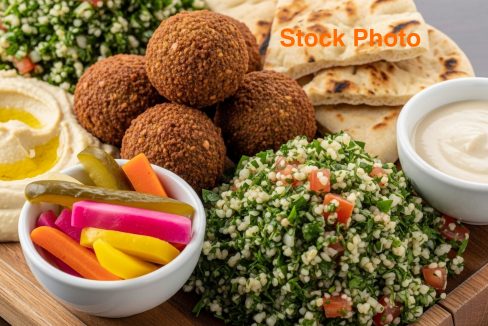 vecteezy_a-plate-with-a-variety-of-food-including-bread-pita-and_71354881