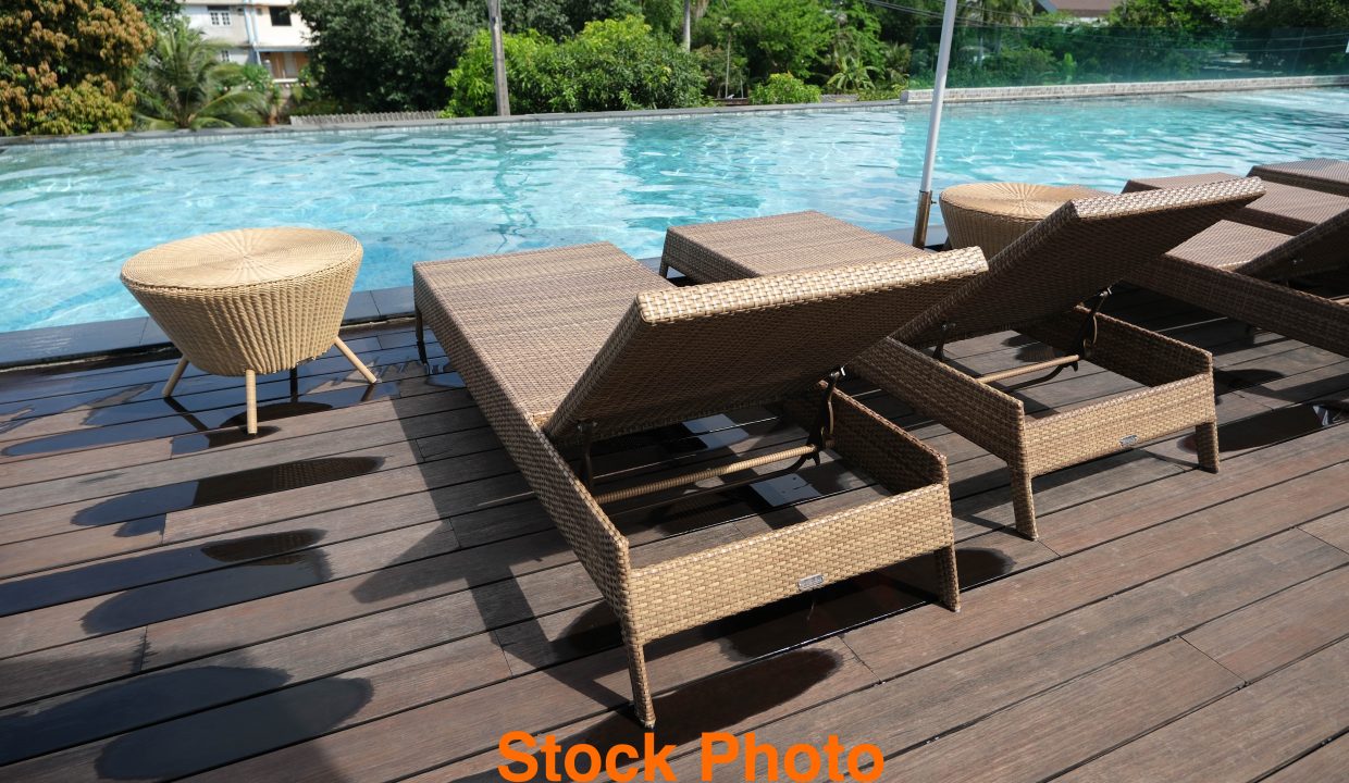 Poolside chairs, outdoor pool on the hotel