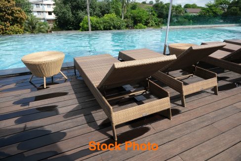 Poolside chairs, outdoor pool on the hotel